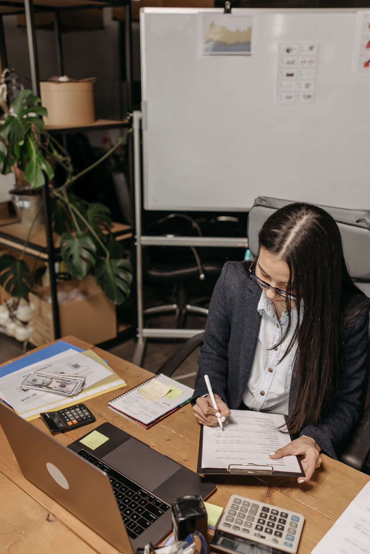 An accountant working through paperwork at a desk