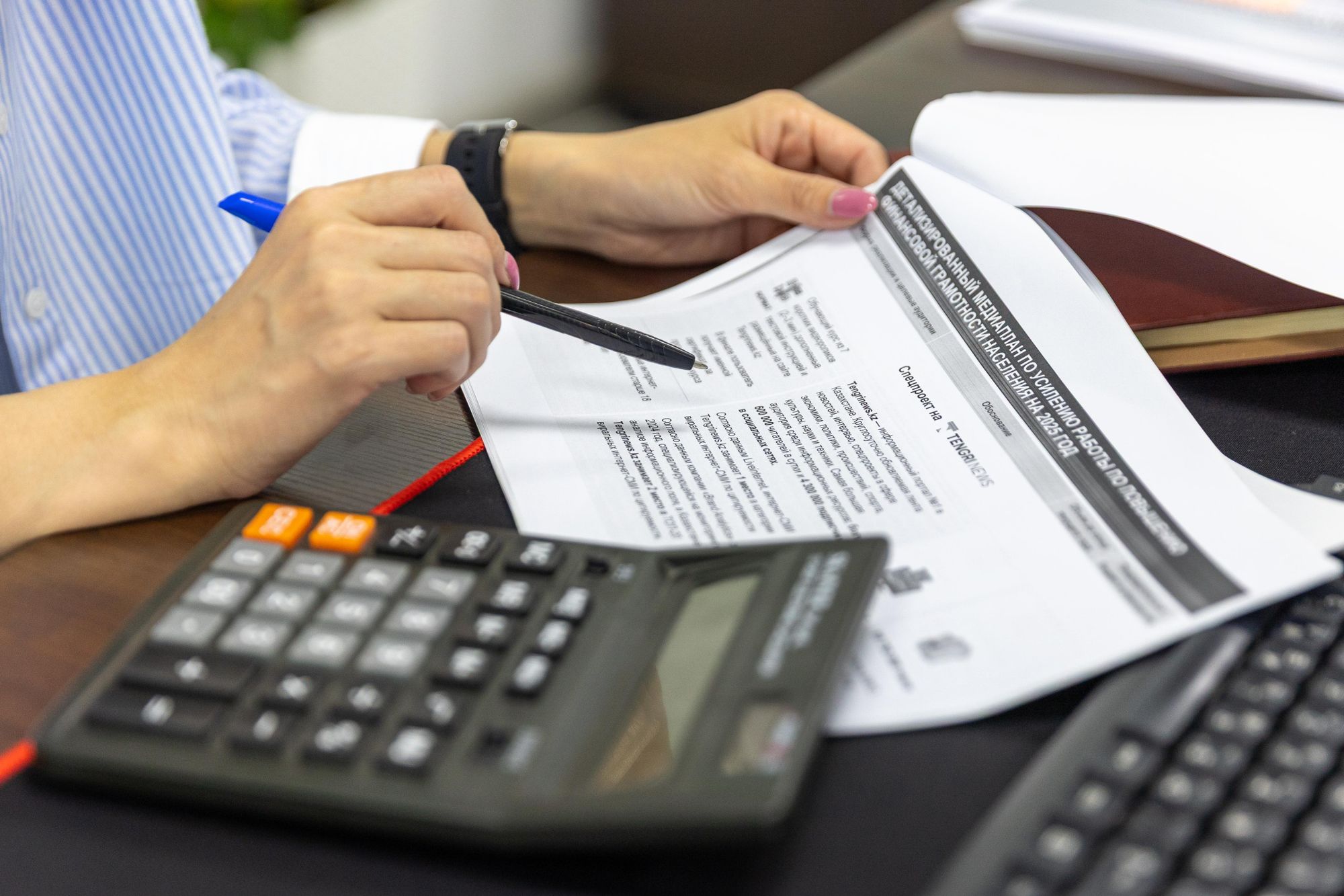 A calculator and tax paperwork on a desk
