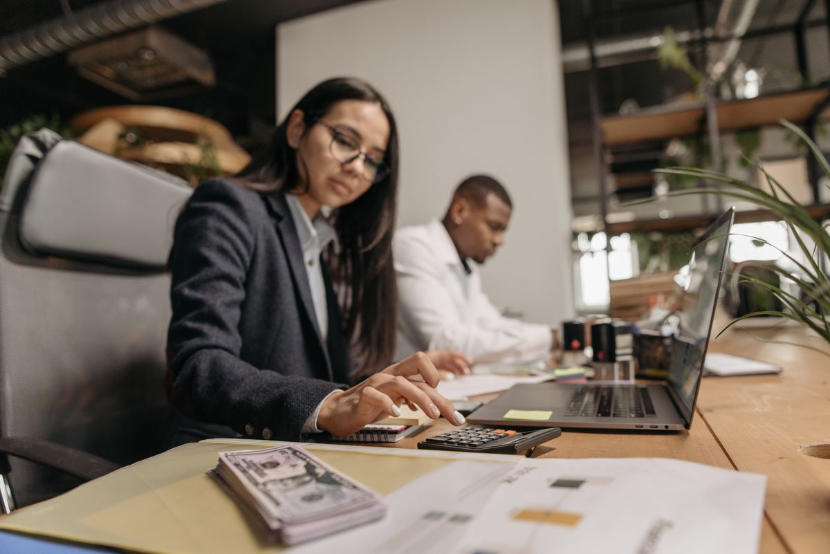 Two accountants working through figures together