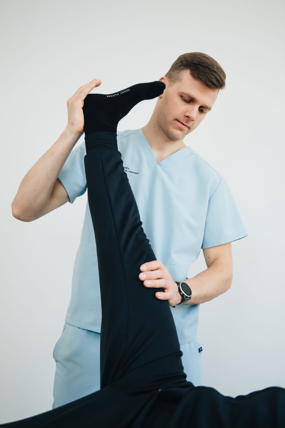 A physio stretching a patient's hamstring